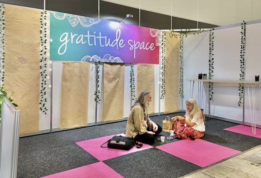 Two people sitting cross legged on carpet